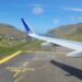 Plane wing and Faroese views through the plane window just after landing