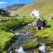 Mountain stream and houses around it in Gjogv