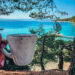 Cup of coffee and the view of sea with turquise waters and beach, Bol in Croatia