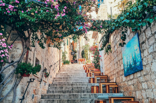 Cobblestone steps in one of the streets in Hvar, with tables and a lot of flowers